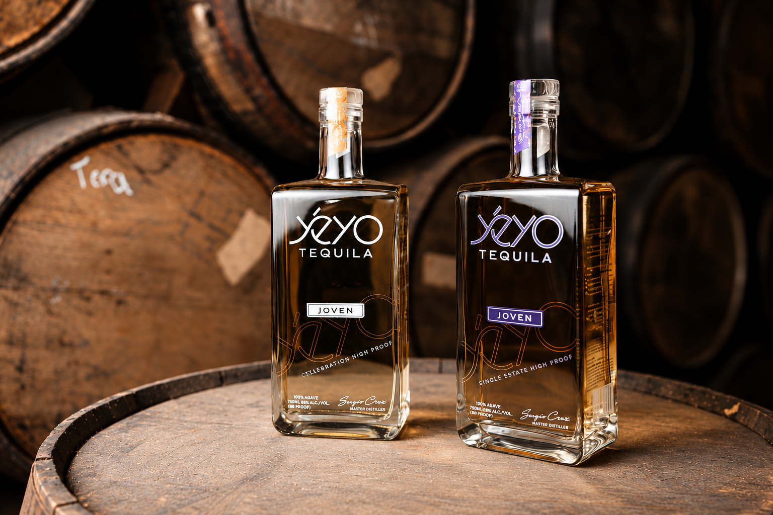 Yéyo Joven Celebration and Single Estate High Proof bottles resting on a barrel inside the barrel room